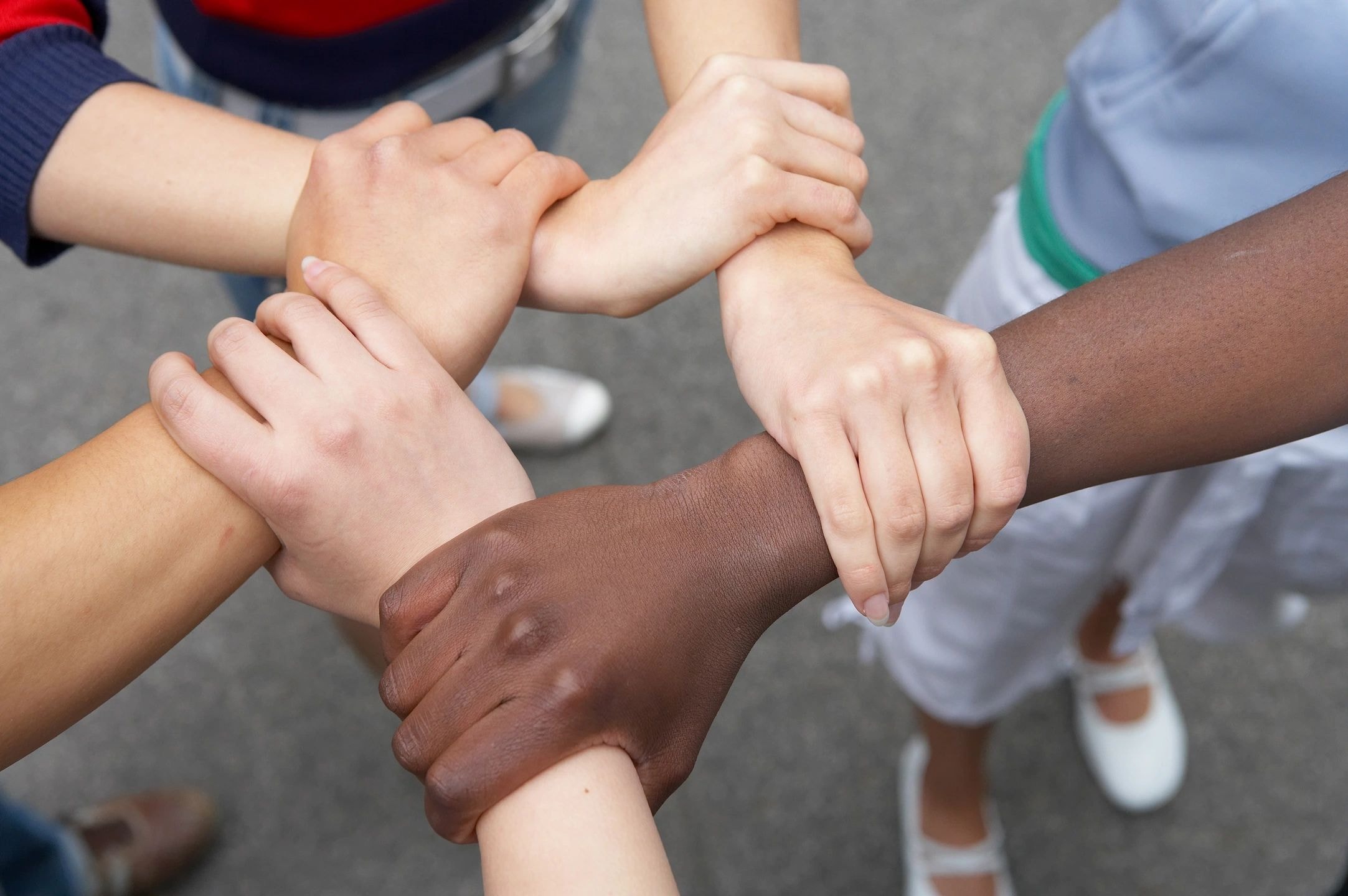 Diverse children's hands joined together in teamwork